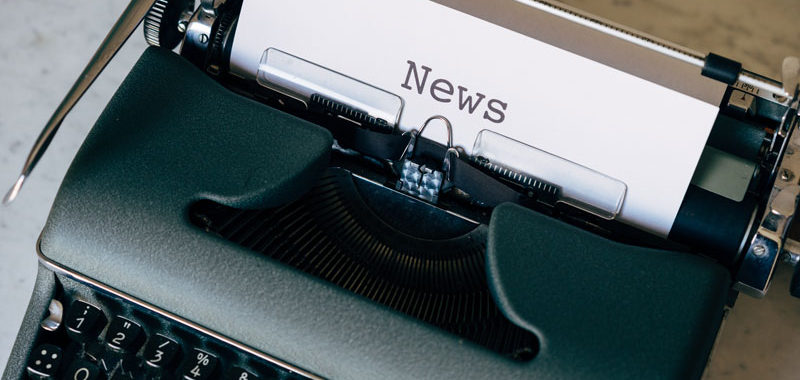 a typewriter with paper that says news in it