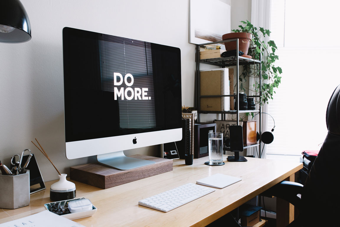 a computer that says do more on it on a desk