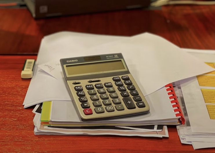 a calculator on a pile of paper