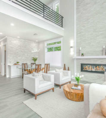 a living room area that looks staged with a nice couch and fire place