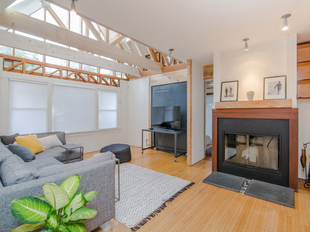 a staged living room area with a fire place and couch