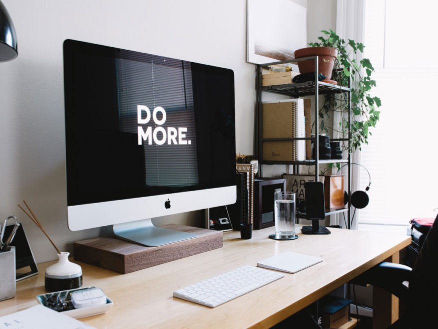 a computer that says do more on it on a desk